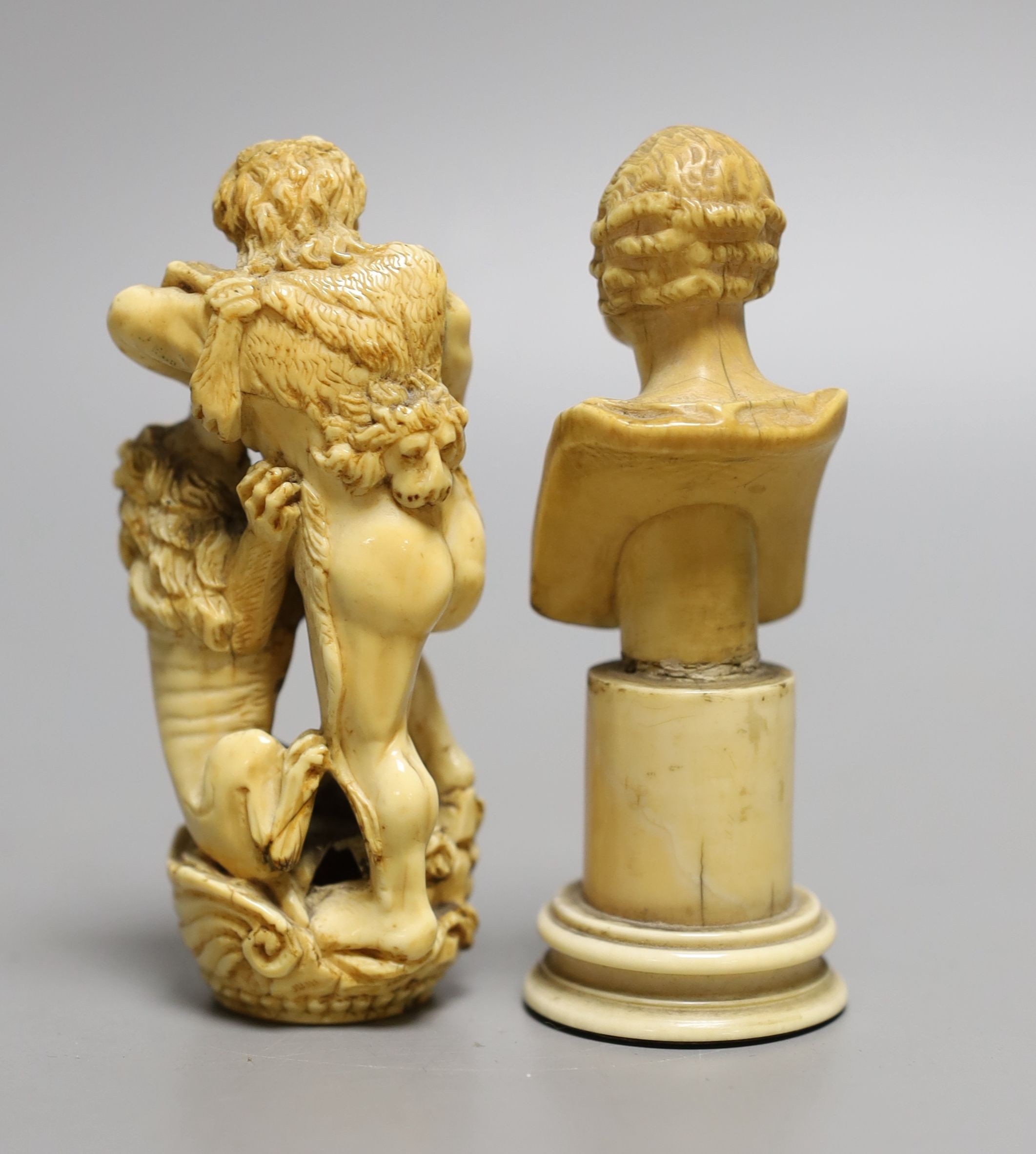 An ivory finial or cane handle in the form of Hercules fighting a lion and an ivory bust of a gentleman on a pedestal, both 18th/19th century, finial 9.5 cms high.